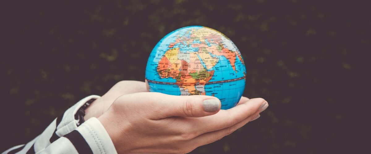 Hand holding globe
