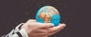 Hand holding globe