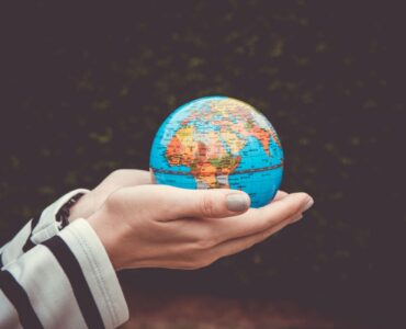 Hand holding globe