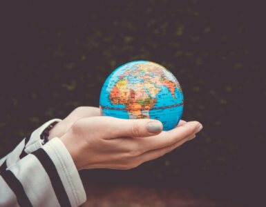 Hand holding globe